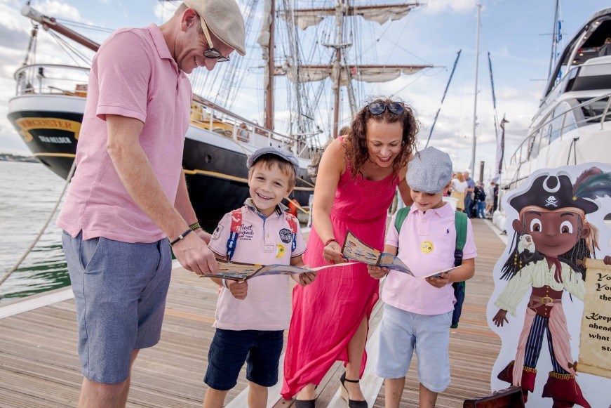 A family looking at a map on a pontoon at Southampton International Boat Show