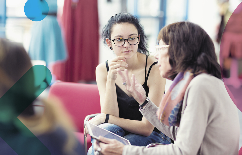 Older and younger social worker talking