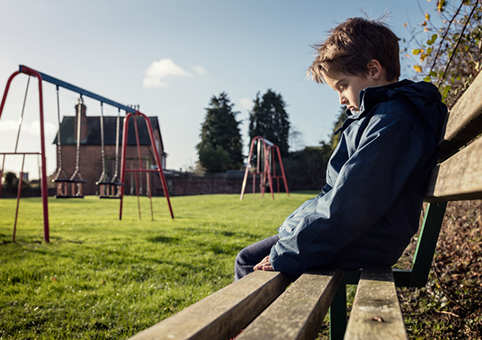 Child alone on a bench