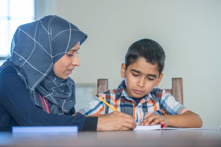 A mother helping her son study