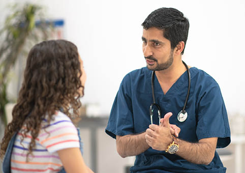 A nurse speaking to a pupil