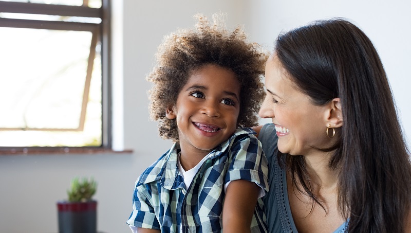 Mother and adopted son smiling