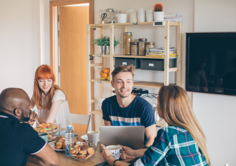 Group of adults around a kitchen table