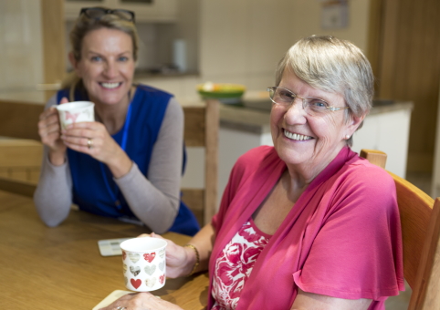 Elderly woman enjoying cuppa with support worker
