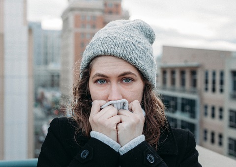 A woman outside in warm winter clothes
