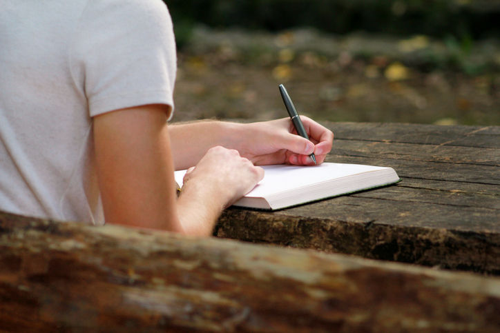 A person writing in a book