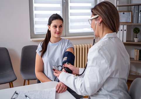 A woman being checked by a doctor