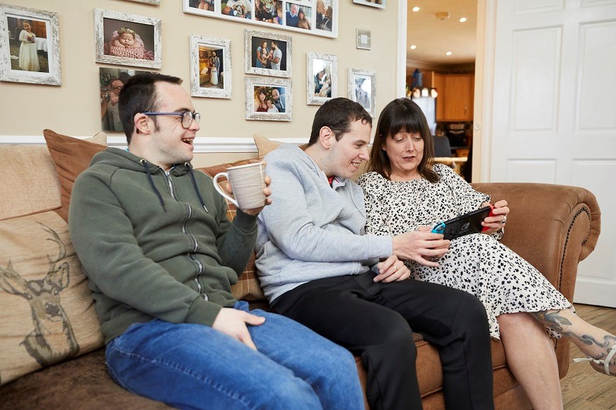 Family sitting on sofa with Nintendo Switch