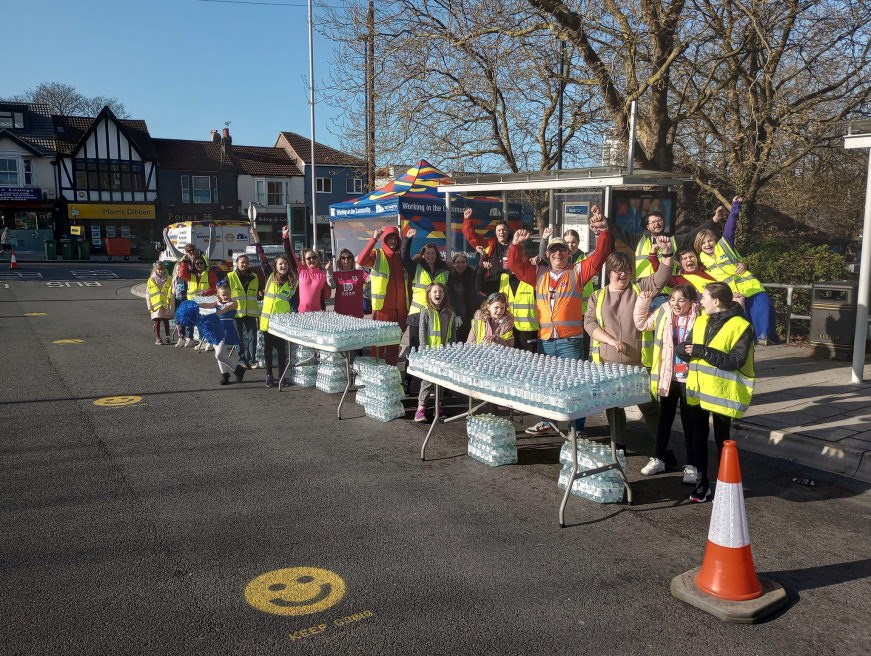 A group photo showing the Junior Neighbourhood Wardens ready to hand out water