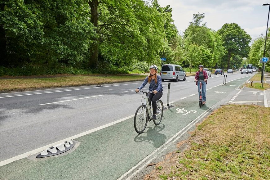 Two cyclists riding in a cycle lane