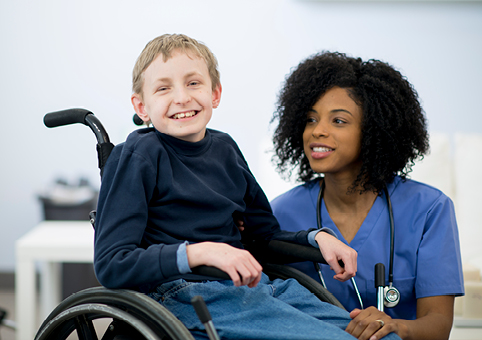 Child in a wheelchair with a nurse