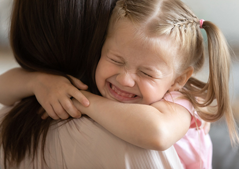 Adult and child hugging