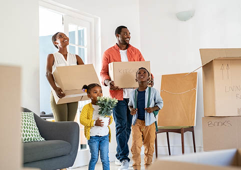 Family walking into a home with boxes