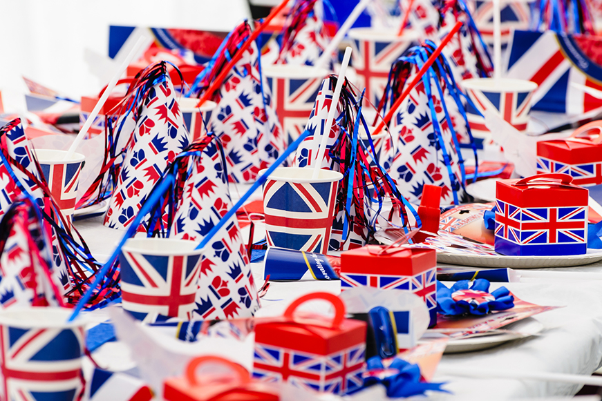 Union Jack celebration items including hats, cups and rosettes