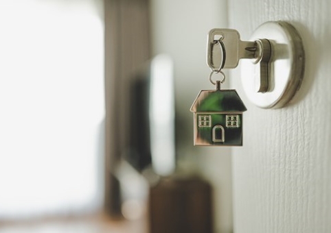 Key in door with house keychain